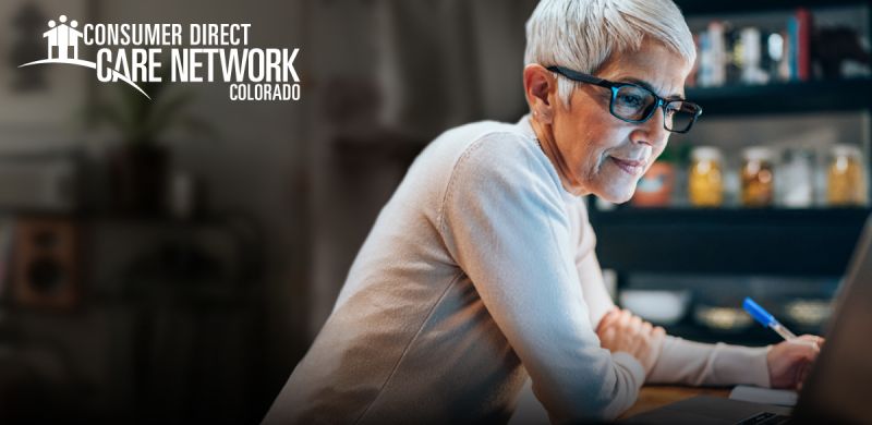 Woman wearing glasses working on her computer.
